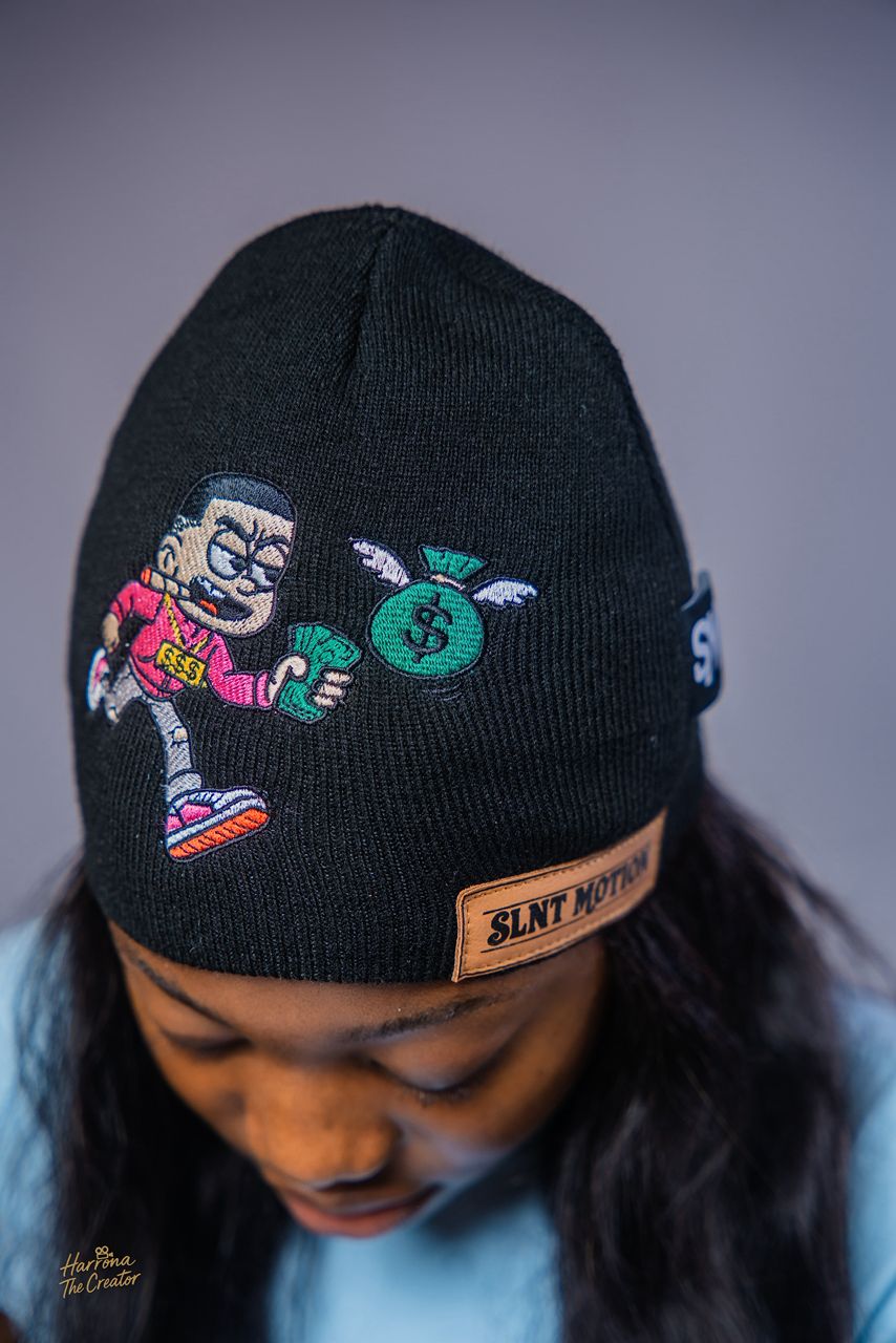 Model wearing the SLNT MOTION Limited Edition Beanie, close on the embroidered graphic
